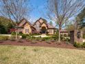 Charming brick home with lush landscaping, mature trees, and a well-manicured lawn for idyllic living at 3505 Jonaway Cir, Fuquay Varina, NC 27526