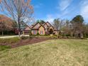 Beautiful brick home showcasing mature landscaping and an expansive lawn, creating a serene outdoor space at 3505 Jonaway Cir, Fuquay Varina, NC 27526