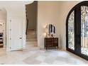 Elegant foyer featuring marble floors, a grand staircase, and an ornate iron door, setting a luxurious tone at 3505 Jonaway Cir, Fuquay Varina, NC 27526