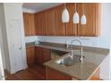 Kitchen island with stainless steel sink, granite countertops, and decorative pendant lights at 3537 Layton Ridge Dr, Apex, NC 27539