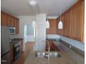 Well-lit kitchen with granite countertops, stainless steel sink, and pendant lighting at 3537 Layton Ridge Dr, Apex, NC 27539