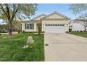 Inviting home with a well-maintained lawn, concrete driveway, and attached two-car garage at 408 Indian Elm Ln, Cary, NC 27519