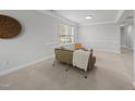 Cozy living room featuring neutral colors and carpeted floors, illuminated by a bright window at 408 Indian Elm Ln, Cary, NC 27519