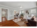 Bright living room featuring hardwood floors, large windows, and stylish furniture at 410 N Hyde Park Ave, Durham, NC 27703