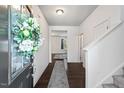 Welcoming foyer with hardwood floors, a staircase, and a decorative wreath on the front door at 433 Mockingbird Ln, Mebane, NC 27302