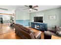 Cozy living room featuring a ceiling fan and view into the kitchen area at 440 S Church St, Coats, NC 27521
