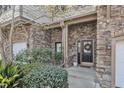 Close up view of the front entrance featuring stone work and attractive landscaping at 4801 Glenmist Ct # 202, Raleigh, NC 27612
