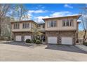Attractive multi-story townhome with stone accents, a 2-car garage, and mature landscaping at 4801 Glenmist Ct # 202, Raleigh, NC 27612
