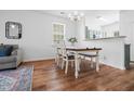 Bright dining room with modern table and wood floors at 5980 Osprey Cove Dr, Raleigh, NC 27604
