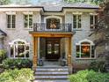 Elegant home entrance featuring a balcony, double doors, and well-maintained landscaping at 6016 Glenthorne Dr, Raleigh, NC 27613