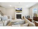Comfortable living room featuring a fireplace, plush seating, and a large television at 705 Marshall Farm St, Wake Forest, NC 27587