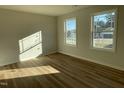 Bright bedroom features wood flooring and two large windows offering natural light at 77 Heatherglenn Cir, Princeton, NC 27569