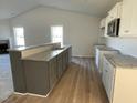 Modern kitchen with granite countertops, gray cabinets, and stainless steel appliances at 77 Heatherglenn Cir, Princeton, NC 27569
