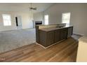 Open-concept kitchen featuring a granite island with sink overlooking the living area at 77 Heatherglenn Cir, Princeton, NC 27569