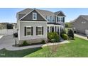 Attractive two-story home with a well-kept lawn, landscaping and a side-entry two-car garage at 834 November Ln, Willow Springs, NC 27592