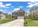 Beautiful two-story home boasting a manicured lawn, large driveway, and brick and vinyl siding at 1000 Milkweed Ct, Zebulon, NC 27597