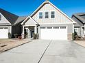 Charming home with a white garage door and well-maintained landscaping at 103 Thornwhistle Pl, Garner, NC 27529