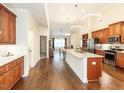 Spacious kitchen with hardwood floors, stainless steel appliances, and granite countertops at 103 Thornwhistle Pl, Garner, NC 27529