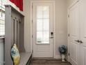 Bright foyer featuring a coat rack and a glass-paneled front door, offering a warm welcome at 107 Canary Ct, Raleigh, NC 27610