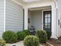 Inviting front porch with charming chairs and lush landscaping, perfect for relaxing outdoors at 107 Canary Ct, Raleigh, NC 27610