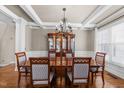 Elegant dining room features coffered ceilings, hardwood floors, and bright windows at 107 Zaharis Cv, Raleigh, NC 27603