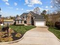 Charming two-story home with manicured lawn, mature landscaping and a long driveway at 107 Zaharis Cv, Raleigh, NC 27603