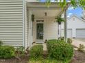 Inviting front porch with decorative plants, creating a welcoming entrance to the home at 1116 Silky Dogwood Trl, Apex, NC 27502