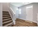 Bright entryway with wood floors, stairs, and white trim, creating a welcoming and open space at 112 Willow Grove Ln, Fuquay Varina, NC 27526