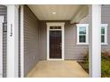 Inviting front door entrance with white trim and columns, offering a warm welcome to guests at 112 Willow Grove Ln, Fuquay Varina, NC 27526