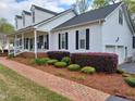 Charming home featuring a brick walkway, well-maintained landscaping, and an attached two-car garage at 117 Linwood Ln, Clayton, NC 27527