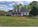 Traditional home with a lush green lawn, showcasing its inviting front porch and manicured landscaping at 117 Linwood Ln, Clayton, NC 27527