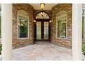 Elegant front entrance with stone accents, arched transom, and decorative double doors at 1217 Mauldin Rd, Wake Forest, NC 27587