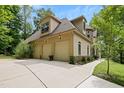 Spacious three-car garage with ample parking space and well-maintained landscaping at 1217 Mauldin Rd, Wake Forest, NC 27587