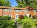 Traditional brick townhome with well-maintained landscaping and a welcoming entrance at 1220 Manassas Ct Ct # E, Raleigh, NC 27609