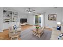 Inviting living area with sliding glass doors, wood flooring and built-in shelves at 1220 Manassas Ct Ct # E, Raleigh, NC 27609