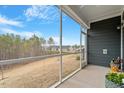 Enjoy a scenic view from this screened porch overlooking the backyard and beyond at 1243 White Flint Cir, Durham, NC 27703