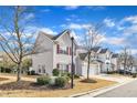 Attractive two-story home with red shutters, showing manicured lawn and attached garage, under blue skies at 125 Hidden Springs Dr, Durham, NC 27703