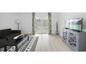 Inviting living room with light wood floors, contemporary furniture, and sliding glass doors to outdoor at 1277 Teakwood Pl, Raleigh, NC 27606