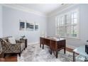 Serene home office with natural light, wood floors, crown molding, and neutral decor at 144 Arabella Ct, Cary, NC 27518