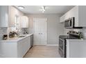 Bright kitchen features white cabinets, stainless steel appliances, and modern countertops at 1620 Briarmont Ct, Raleigh, NC 27610