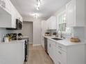 Updated kitchen featuring white cabinets, stainless steel appliances, and modern fixtures at 206 Woods Run, Knightdale, NC 27545
