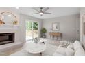 Bright living room featuring fireplace, hardwood floors, and sliding door access to the outdoor deck at 206 Woods Run, Knightdale, NC 27545