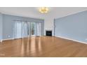 Spacious living room with hardwood floors, fireplace, and access to outdoor deck at 208 Chandler Chase Ct, Morrisville, NC 27560
