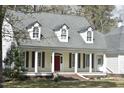 Inviting home with a welcoming porch supported by elegant columns and eye-catching dormer windows at 218 Keith Hills Rd, Lillington, NC 27546