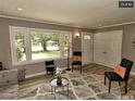 Bright living room featuring a large window, stylish seating, and hardwood floors at 220 Barclay Rd, Chapel Hill, NC 27516