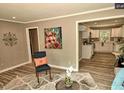 Stylish living room featuring hardwood floors and a view of the kitchen at 220 Barclay Rd, Chapel Hill, NC 27516