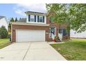 Charming brick home featuring a white garage door, blue shutters, and a welcoming front entrance at 2310 Nutting Ln, Apex, NC 27523