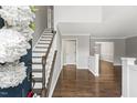 Bright foyer with beautiful hardwood floors, staircase, and views into adjacent living spaces at 2310 Nutting Ln, Apex, NC 27523