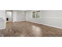 Bright living room with new wood floors and large windows to let the light shine in at 251 W Moffitt Avenue, Liberty, NC 27298