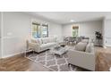 Inviting living room with modern furniture, large windows, and wood floors at 251 W Moffitt Avenue, Liberty, NC 27298